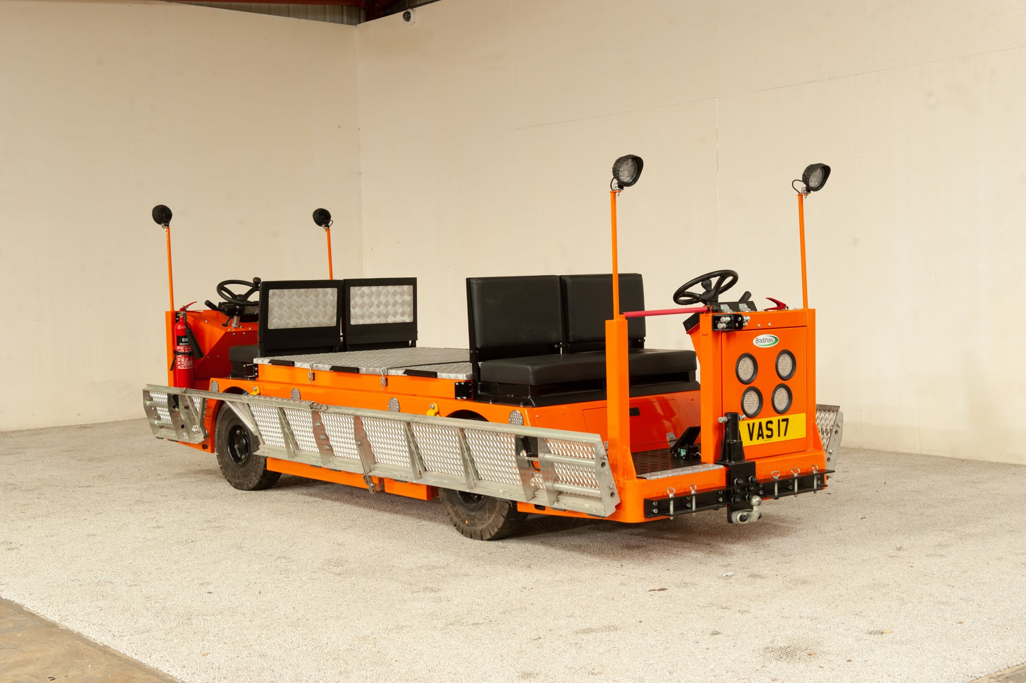 Orange speciality bidirectional tunnel and mining vehicle with driving positions at both ends